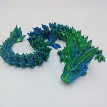 Articulated Crystal Dragon 3D Printed in Blue to Green Articulated Crystal Dragon Sensory Toy in Silk Blue to Green with a White Background