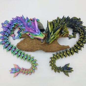 Articulated Crystal Dragon 3D Printed in Great Barrier Reef Rainbow and Black to Gold Articulated Crystal Dragon Sensory Toys in Silk Great Barrier Reef Rainbow and Black to Gold Sitting on a Log from Above with a White Background