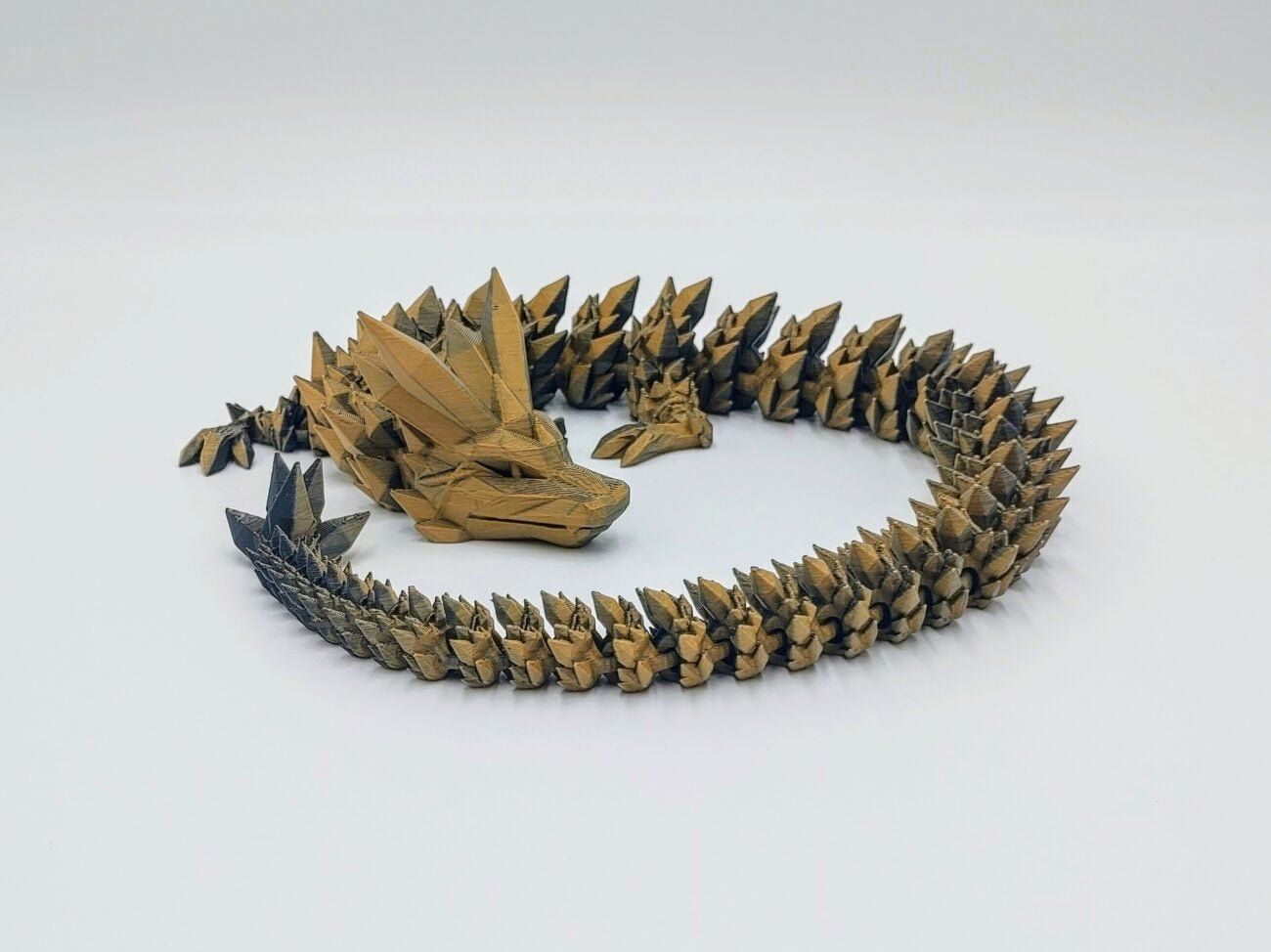 Articulated Crystal Dragon 3D Printed in Matte Orange to Grey Articulated Crystal Dragon Sensory Toy Designed by Cinderwing3d in Matte Orange to Grey with a White Background