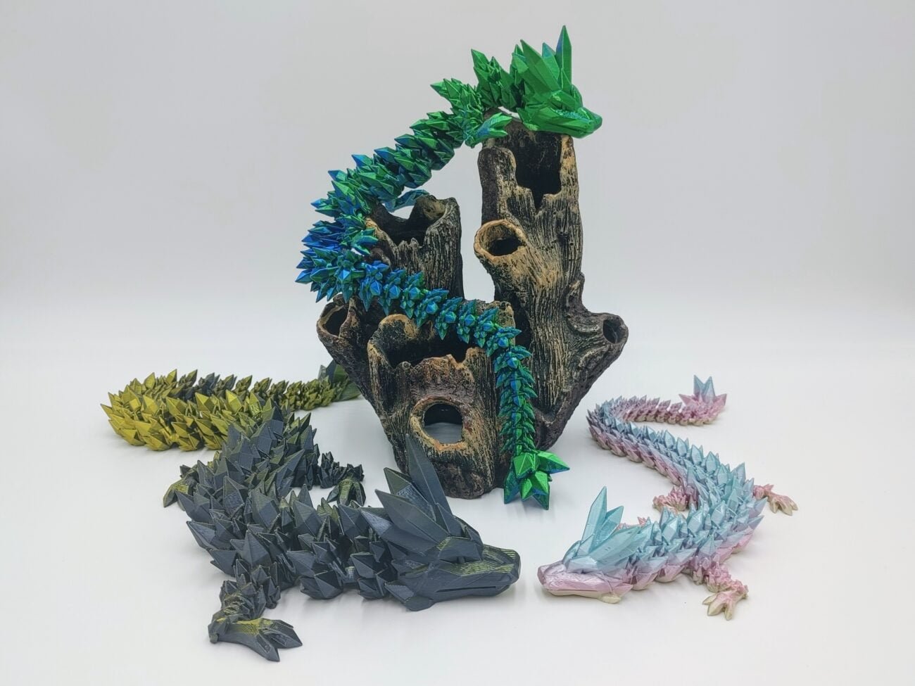 Articulated Crystal Dragon 3D Printed in Silk Colours Articulated Crystal Dragon Sensory Toys in Silk Colours Sitting on Coral with a White Background