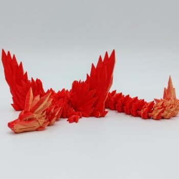 Articulated Crystalwing Dragon 3D Printed in Matte Red to Yellow Articulated Crystalwing Dragon Sensory Toys in Matte Red to Yellow Sitting on Rocks on a White Background
