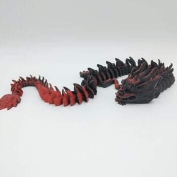Articulated Imperial Dragon 3D Printed in Matte Red to Black Articulated Imperial Dragon Sensory Toys Designed by Flexy Factory in Matte Red to Black with a White Background