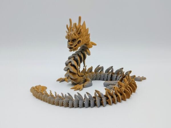 Articulated Imperial Dragon Sensory Toys Designed by Flexy Factory in Matte Orange to Grey Sitting on Rocks with a White Background